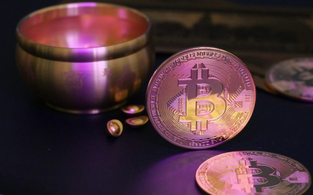Bitcoin coins next to a bowl with a glowing hue